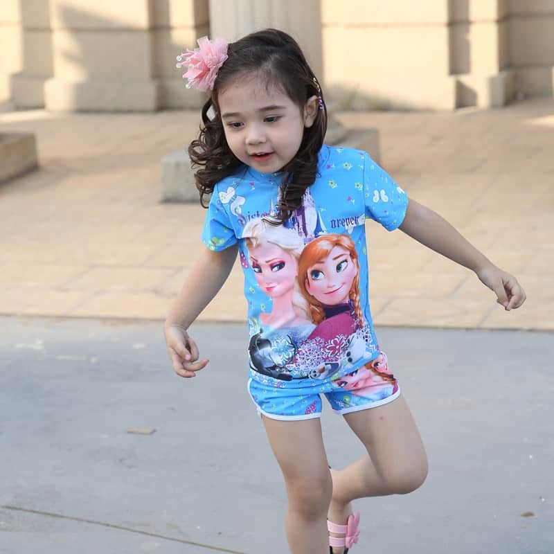 A little girl standing on a sidewalk